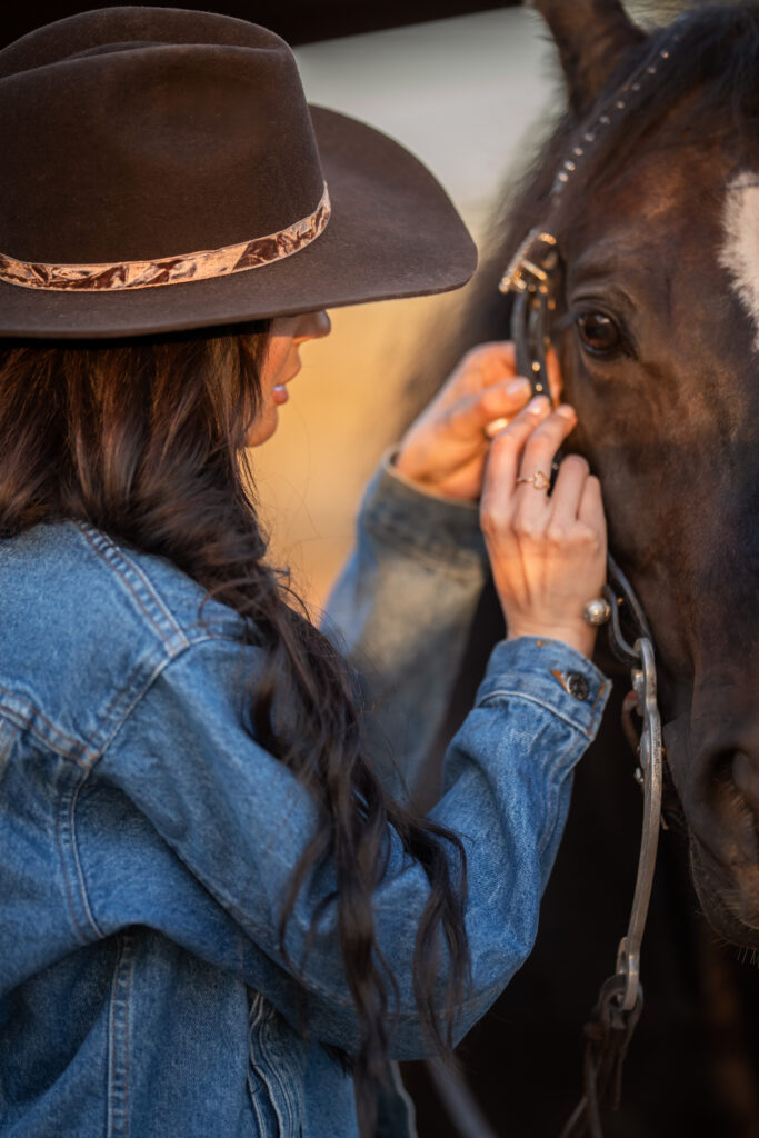 woman adjusting her horse's bridle